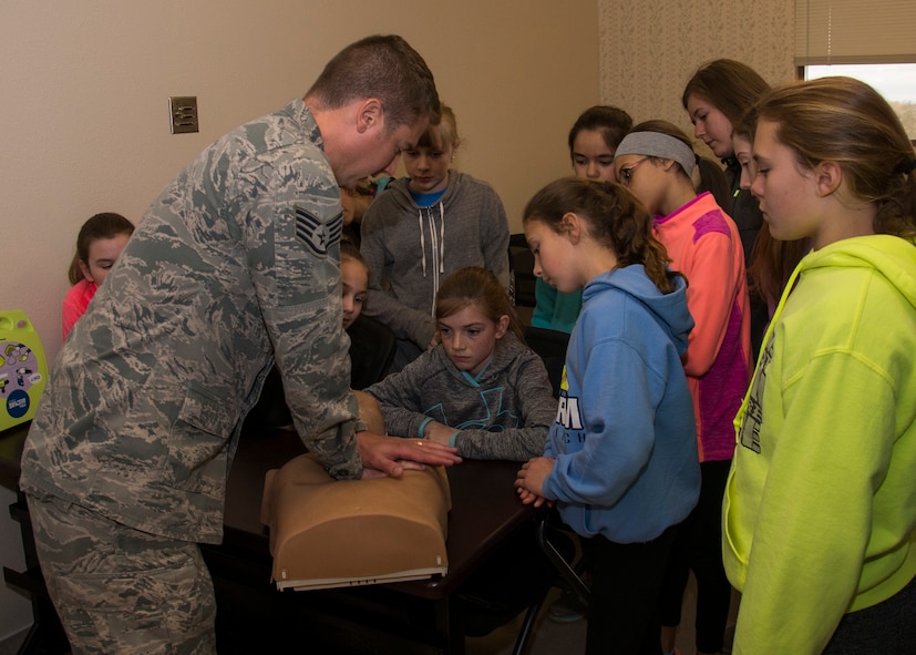 Staff Sgt. Michael Mattice, 5th Medical Group NCO-in-charge of education and training, teaches Edison Elementary School’s science, technology, engineering and math girls CPR at Minot Air Force Base, N.D., May 1, 2017. The STEM girls visited Radiology, Immunizations and the training section of the 5th Medical Group during their tour. (U.S. Air Force photo/Airman 1st Class Alyssa M. Akers)