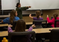 1st Lt. Katelyn Woodley, 741st Missile Squadron intercontinental ballistic missile combat crew commander, teaches Edison Elementary School’s science, technology, engineering and math girls to launch a missile at the Missile Procedures Trainer on Minot Air Force Base, N.D., May 1, 2017. The STEM girls learned the basics of a missileer’s job, including the necessary procedures of a missile launch. (U.S. Air Force photo/Airman 1st Class Alyssa M. Akers)