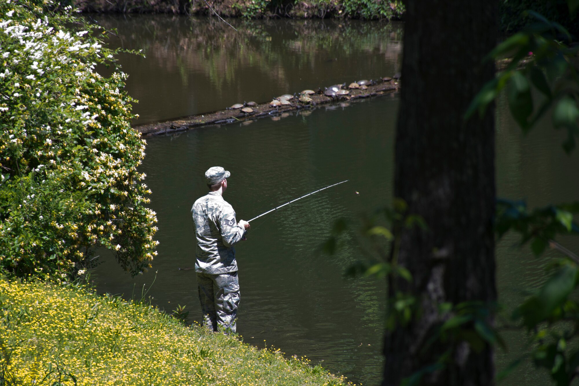 A U.S. Air Force Airman takes time out to relax and go fishing near The Old Mill located in T.R. Pugh Memorial Park, North Little Rock, Ark., April 24, 2017. The mill is part of a comprehensive system of recreational lakes and open spaces in the Lakewood residential area. (U.S. Air Force photo by Master Sgt. Jeff Walston/Released)