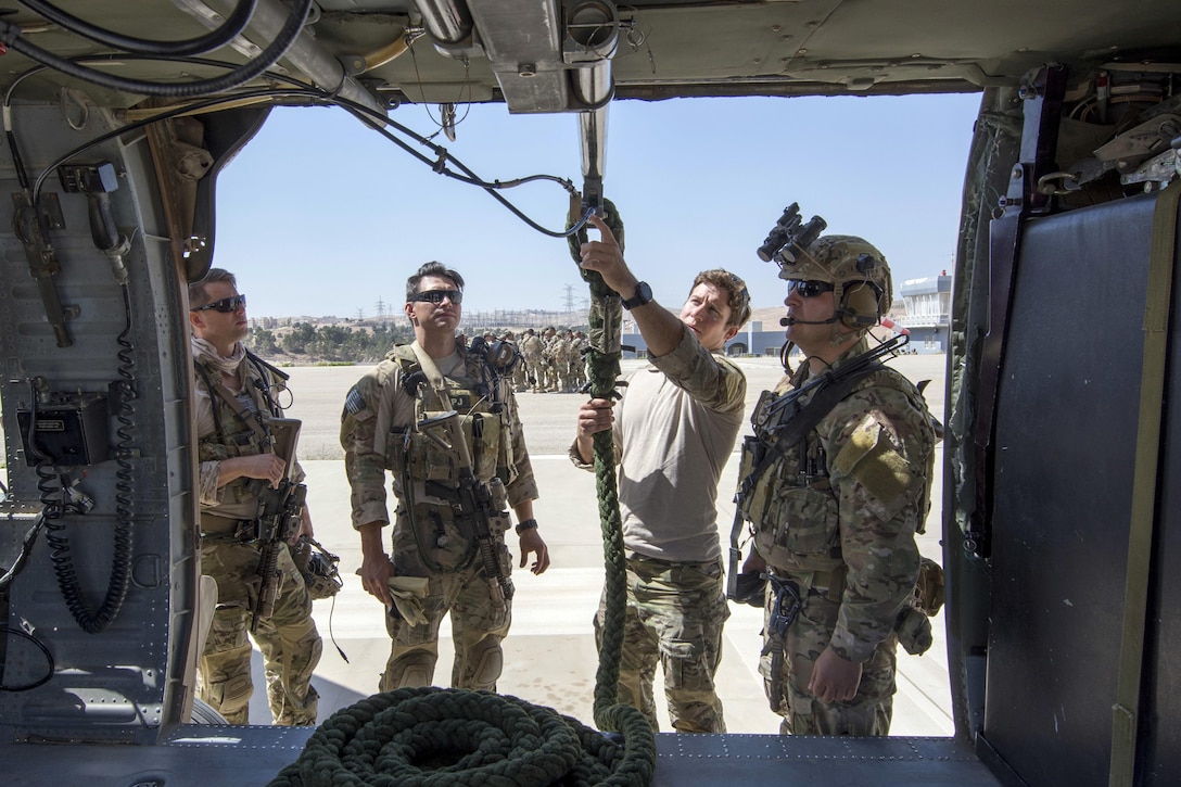 Members of the Air Force Special Operation's 23rd Special Tactics Squad inspect equipment prior to a fast-roping exercise during Eager Lion 2017 in Amman, Jordan, May 7, 2017. Navy photo by Petty Officer 2nd Class Christopher Lange