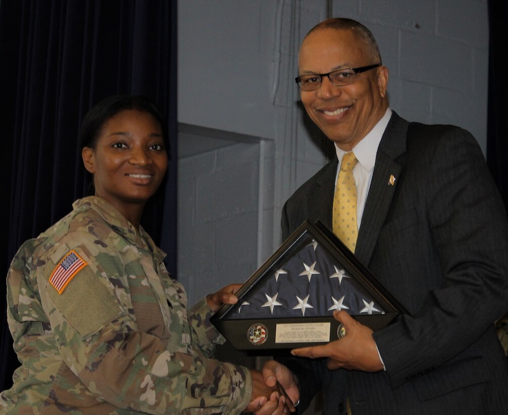 U.S. Army Sgt. Christine Clark (left), an Army Reserve Soldier and warrant officer candidate assigned to the North Capital Region Cyber Protection Center, Army Reserve Cyber Operations Group (ARCOG), 335th Signal Command (Theater), receives a U.S. Flag by Lt. Governor Boyd Rutherford, the lieutenant governor of Maryland, during a welcome home ceremony April 2 at Fort Meade, Maryland. Clark, who was deployed with the NCRCPC’s Detachment 21, completed a tour in Kuwait where the Detachment conducted cyber missions and training under the U.S. Army Central Command. (U.S. Army Reserve Photo by Sgt. Erick Yates)