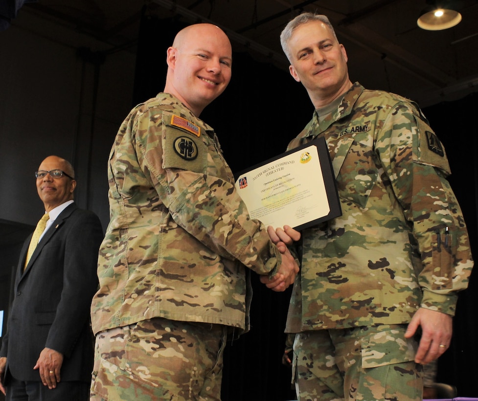 U.S. Army Sgt. 1st Class Thomas Tufts (left), an Army Reserve Soldier assigned to the North Capital Region Cyber Protection Center, Army Reserve Cyber Operations Group (ARCOG), 335th Signal Command (Theater), receives a certificate of appreciation from Col. Michael D. Smith, commander of the ARCOG, during a welcome home ceremony April 2 at Fort Meade, Maryland. The Detachment was deployed to Kuwait to conduct cyber missions and training under the U.S. Army Central Command. (U.S. Army Reserve Photo by Sgt. Erick Yates)