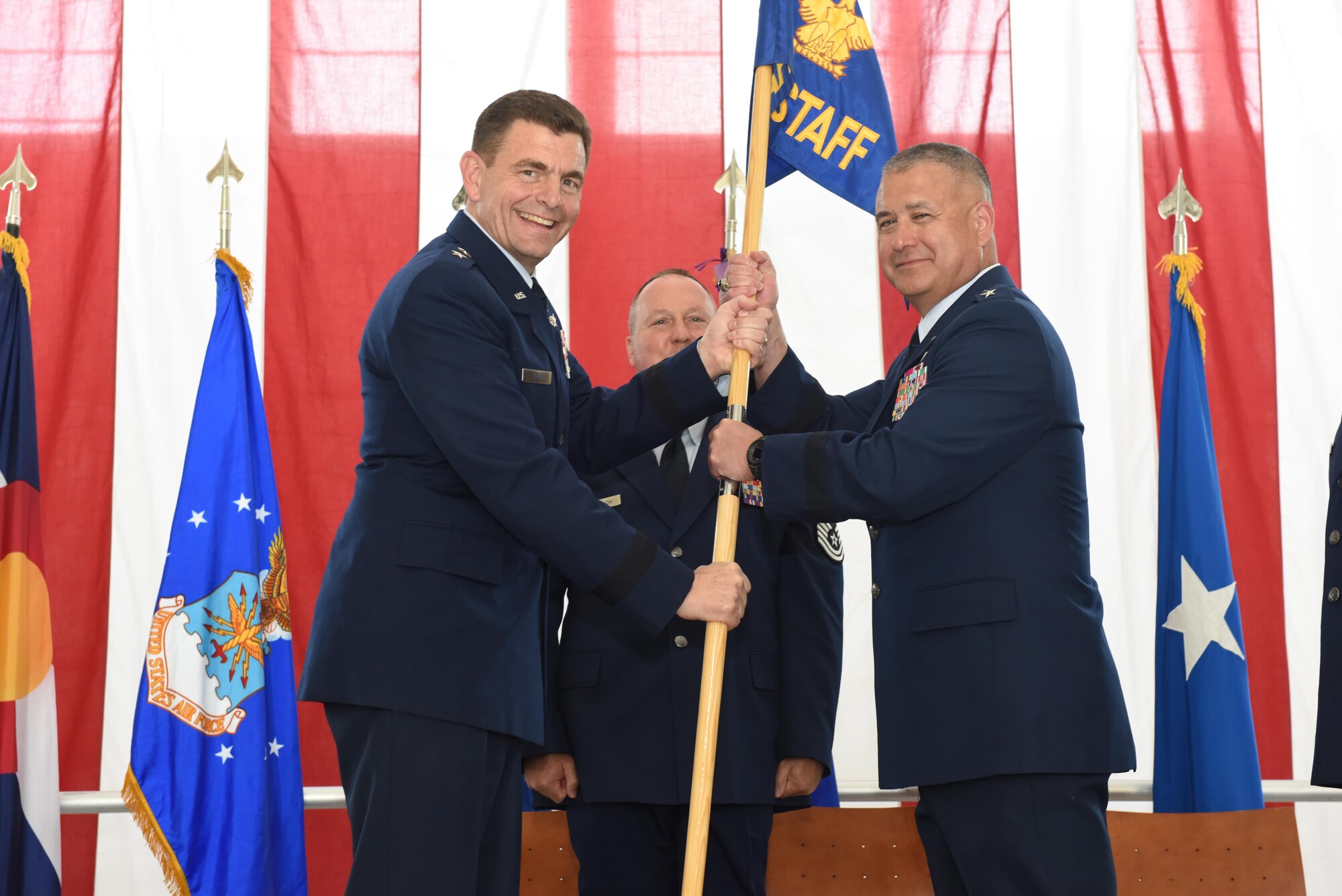 Air Force Maj. Gen. Michael Loh, Adjutant General for the state of Colorado, presents the guidon to Brig. Gen. Floyd Dunstan, as he assumes command of the Colorado Air National Guard as the Assistant Adjutant General, May 6, 2017, Buckley Air Force Base, Aurora, Colo. The change of command ceremony is a deeply rooted military tradition that represents the formal transfer of authority and responsibility for a unit from one commanding officer to another.  (U.S. Air National Guard photo by Staff Sgt. Michelle Y. Alvarez-Rea)