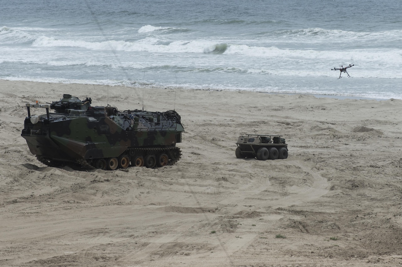 An unmanned aerial vehicle launches from a multi-utility tactical transport vehicle after exiting from an autonomous assault amphibious vehicle during Ship-to-Shore Maneuver Exploration and Experimentation Advanced Naval Technology Exercise 2017 at Marine Corps Base Camp Pendleton, California, April 25, 2017. Navy photo by John F. Williams