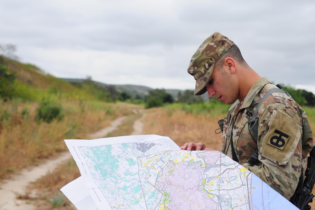 Sgt. Carlos Garcia Velasquez, a human resources specialist with the 90th Sustainment Brigade, looks at a map during the Land Navigation Course portion of the Best Warrior Competition hosted by the 79th SSC at Camp Pendleton, Calif., May 6, 2017. 

The U.S. Army Reserve's 79th Sustainment Support Command hosted their 2017 Best Warrior Competition at Camp Pendleton, Calif., May 3-6. The Best Warrior Competition seeks out the best candidate that defines a U.S. Army Soldier by testing Soldiers physically and mentally. The competition consisted of one enlisted Soldier and one noncommissioned officer from four separate one-star commands, which fall underneath the command and control of 79th SSC. At the conclusion, one Soldier and one NCO were named the 79th SSC Best Warriors and will represent the command in the U.S. Army Reserve Best Warrior Competition held at Fort Bragg, N.C., June 4-10, 2017. (U.S. Army photo by Sgt. Heather Doppke/released)