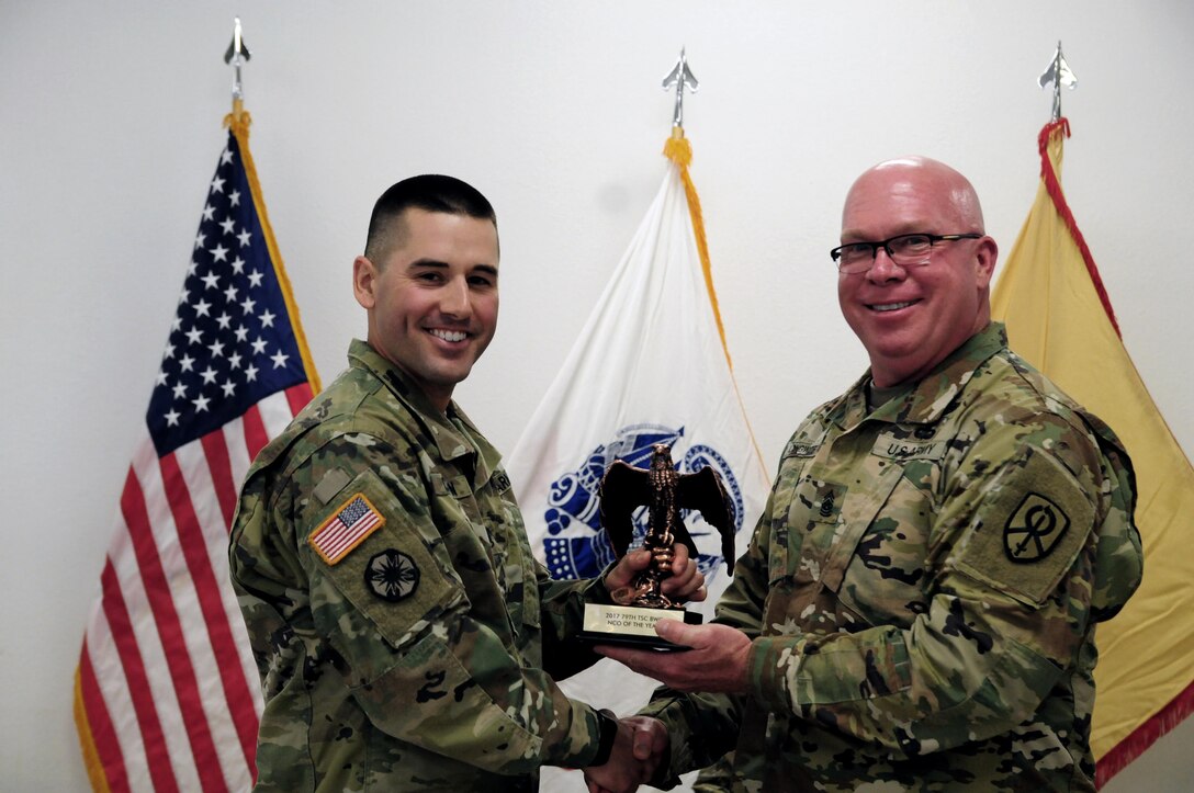 Staff Sgt. Kenneth Chefan, a transportation management coordinator with the 535th Movement Control Team, is awarded by Command Sgt. Maj. Donald E. Langworthy II, interim command sergeant major of the 79th Sustainment Support, during the BWC’s closing ceremony hosted by the 79th SSC at Camp Pendleton, Calif., May 6, 2017.

The U.S. Army Reserve's 79th Sustainment Support Command hosted their 2017 Best Warrior Competition at Camp Pendleton, Calif., May 3-6. The Best Warrior Competition seeks out the best candidate that defines a U.S. Army Soldier by testing Soldiers physically and mentally. The competition consisted of one enlisted Soldier and one noncommissioned officer from four separate one-star commands, which fall underneath the command and control of 79th SSC. At the conclusion, Chefan was named one of the 79th SSC Best Warriors and will represent the command in the U.S. Army Reserve Best Warrior Competition held at Fort Bragg, N.C., June 4-10, 2017. (U.S. Army photo by Sgt. Heather Doppke/released)