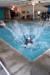 Lt. Col. Nicholas Zetocha, air sovereignty alert commander assigned to the 180th Fighter Wing, Ohio Air National Guard, crashes into the water after being dragged in to simulate an ejection landing May 6, 2017 during water survival training at the Aqua Hut in Toledo, Ohio. 