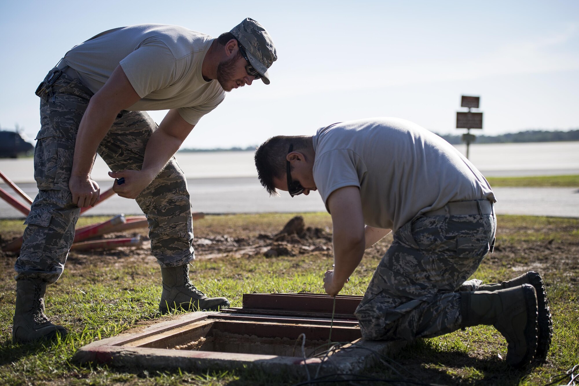 Staff Sgt. Nicholas Worley, 23d Civil Engineer Squadron electrical systems craftsman, walks Senior Airman Pablo Castillo, 23d CES electrical systems journeyman, through the process it takes to remark wires, April 13, 2017, at Moody Air Force Base, Ga. In January 2012, Worley was diagnosed with Chronic Myelogenous Leukemia, an uncommon form of blood-cell cancer that starts in the blood-forming bone marrow cells. He’s currently in remission and goes to the cancer center every three months to ensure his treatment is still working. (U.S. Air Force Photo by Senior Airman Janiqua P. Robinson)