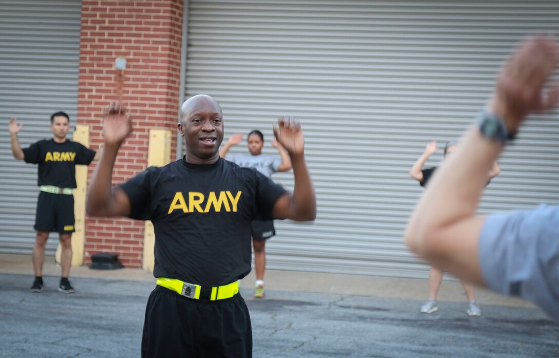 Command Sgt. Maj. Ronnie Farmer, command sergeant major, 335th Signal Command (Theater), leads group physical fitness training at the unit headquarters in East Point, Georgia May 10.  The event included physical readiness training warm-ups, strength training and a 1.5 mile run, as well as cool down exercises. (Official U.S. Army Reserve photo by Sgt. 1st Class Brent C. Powell)