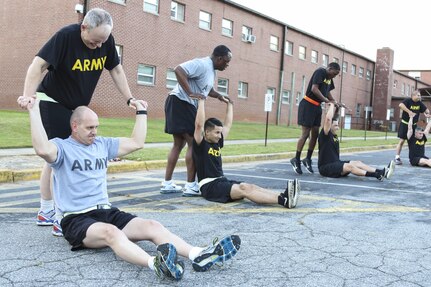 Soldiers from the 335th Signal Command (Theater), conduct a physical resistance exercise during physical fitness training at the unit headquarters in East Point, Georgia May 10.  The event, hosted by Command Sgt. Maj. Ronnie Farmer, command sergeant major, 335th SC (T) included physical readiness training warm-ups, strength training and a 1.5 mile run.  (Official U.S. Army Reserve photo by Sgt. 1st Class Brent C. Powell)