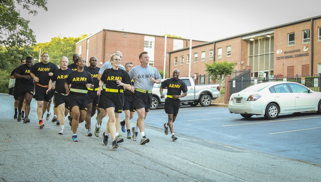 Command Sgt. Maj. Ronnie Farmer, command sergeant major, 335th Signal Command (Theater), leads a group of Soldiers past the unit headquarters building during physical fitness training in East Point, Georgia May 10.  The event, led by Farmer included physical readiness training warm-ups, strength training and a 1.5 mile run.  (Official U.S. Army Reserve photo by Sgt. 1st Class Brent C. Powell)