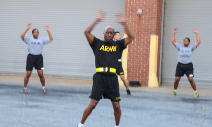 Command Sgt. Maj. Ronnie Farmer, command sergeant major, 335th Signal Command (Theater), leads group physical fitness training at the unit headquarters in East Point, Georgia May 10, ensuring the troops stay Army Strong.  The event included physical readiness training warm-ups, strength training and a 1.5 mile run.  (Official U.S. Army Reserve photo by Sgt. 1st Class Brent C. Powell)