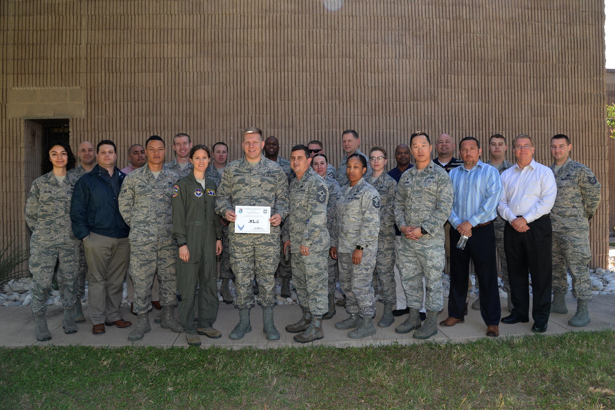 Senior Airman Justin Merritt, 47th Contracting Flight contract specialist (center), accepts the “XLer of the Week” award from Col. Michelle Pryor, 47th Flying Training Wing vice commander (left), and Chief Master Sgt. George Richey, 47th FTW command chief (right), on Laughlin Air Force Base, Texas, May 1, 2017. The XLer is a weekly award chosen by wing leadership and is presented to those who consistently make outstanding contributions to their unit and Laughlin. (U.S. Air Force photo/Technical Sgt. Mike Meares)