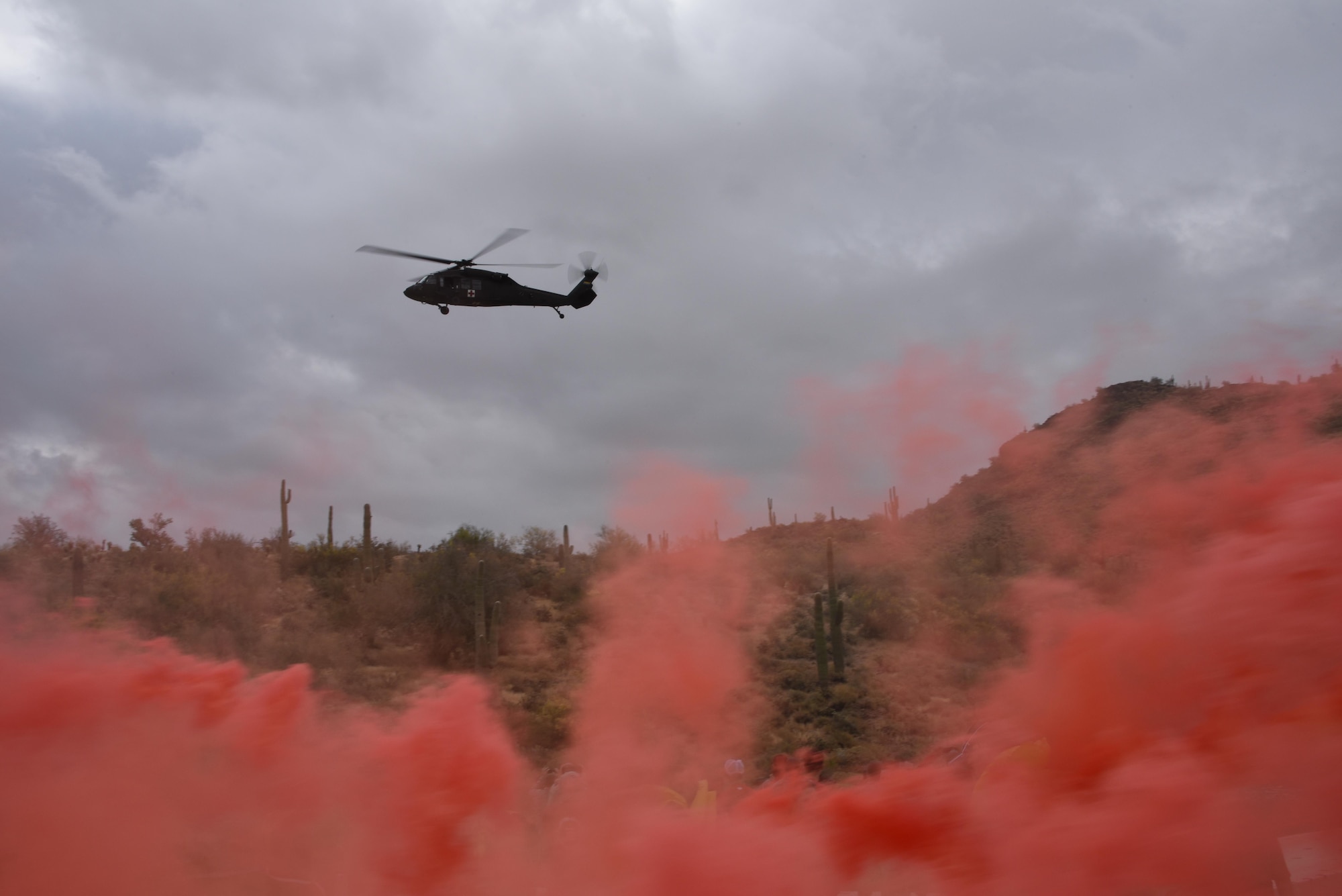 Day-time signal flares are used by aircrew to vector in a UH-60 Blackhawk during a simulated rescue at Lake Pleasant aquatic center, Ariz., May 7, 2017. Water survival training is conducted every two years at the 161st Air Refueling Wing to refresh the aircrew on using the life support equipment on board the aircraft in the event of an emergency. (U.S. Air Force photo by Tech. Sgt. Michael Matkin)