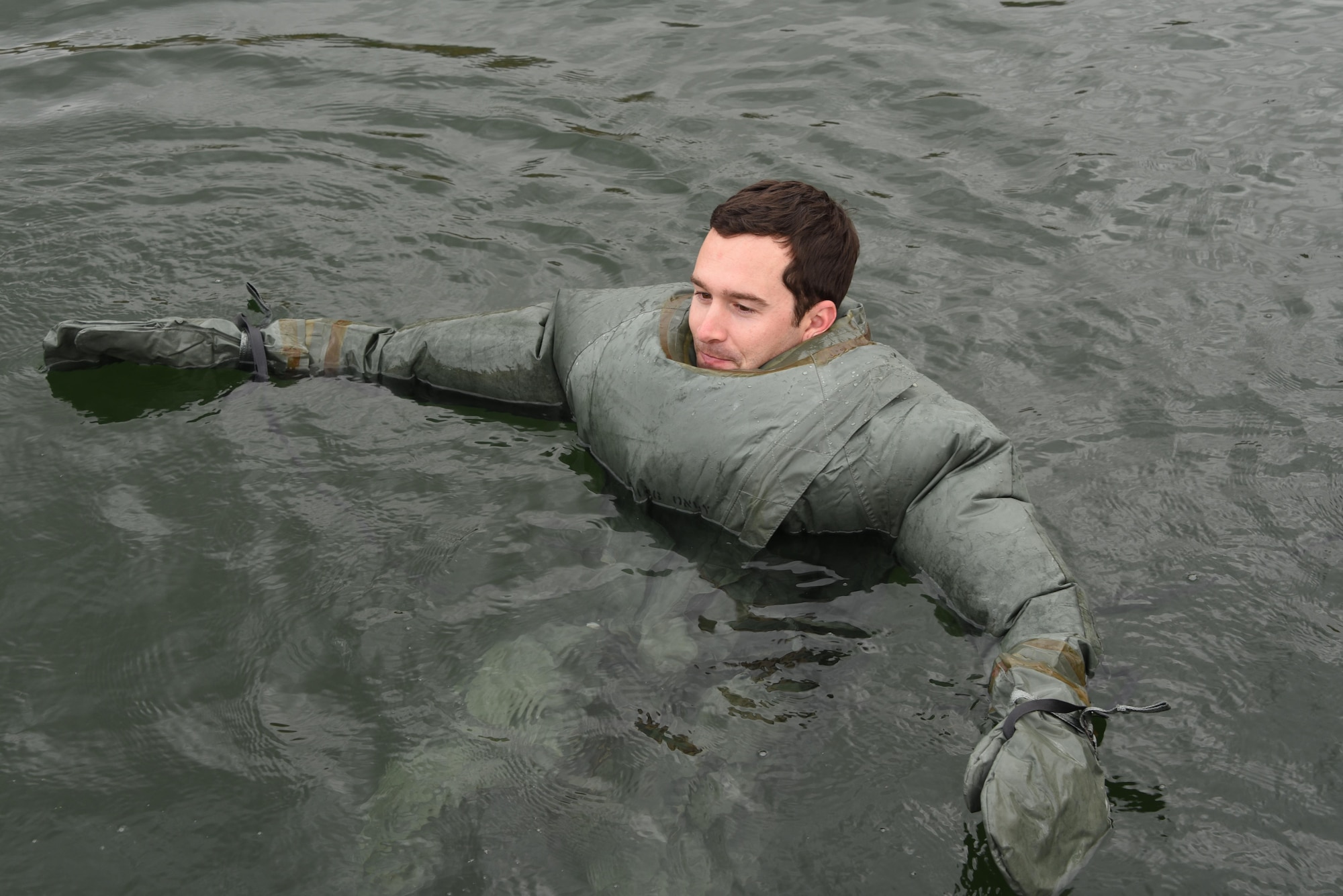 1LT Kevin Irwin, a KC-135 Stratotanker Pilot assigned to the 161st Air Refueling Wing, jumps into the water wearing a CWU-16/P anti-exposure suit during water survival training at Lake Pleasant aquatic center, Ariz., May 7, 2017.  The anti-exposure suit is used to protect aircrew that may need to evacuate the aircraft into cooler water temperatures. (U.S. Air Force photo by Tech. Sgt. Michael Matkin)