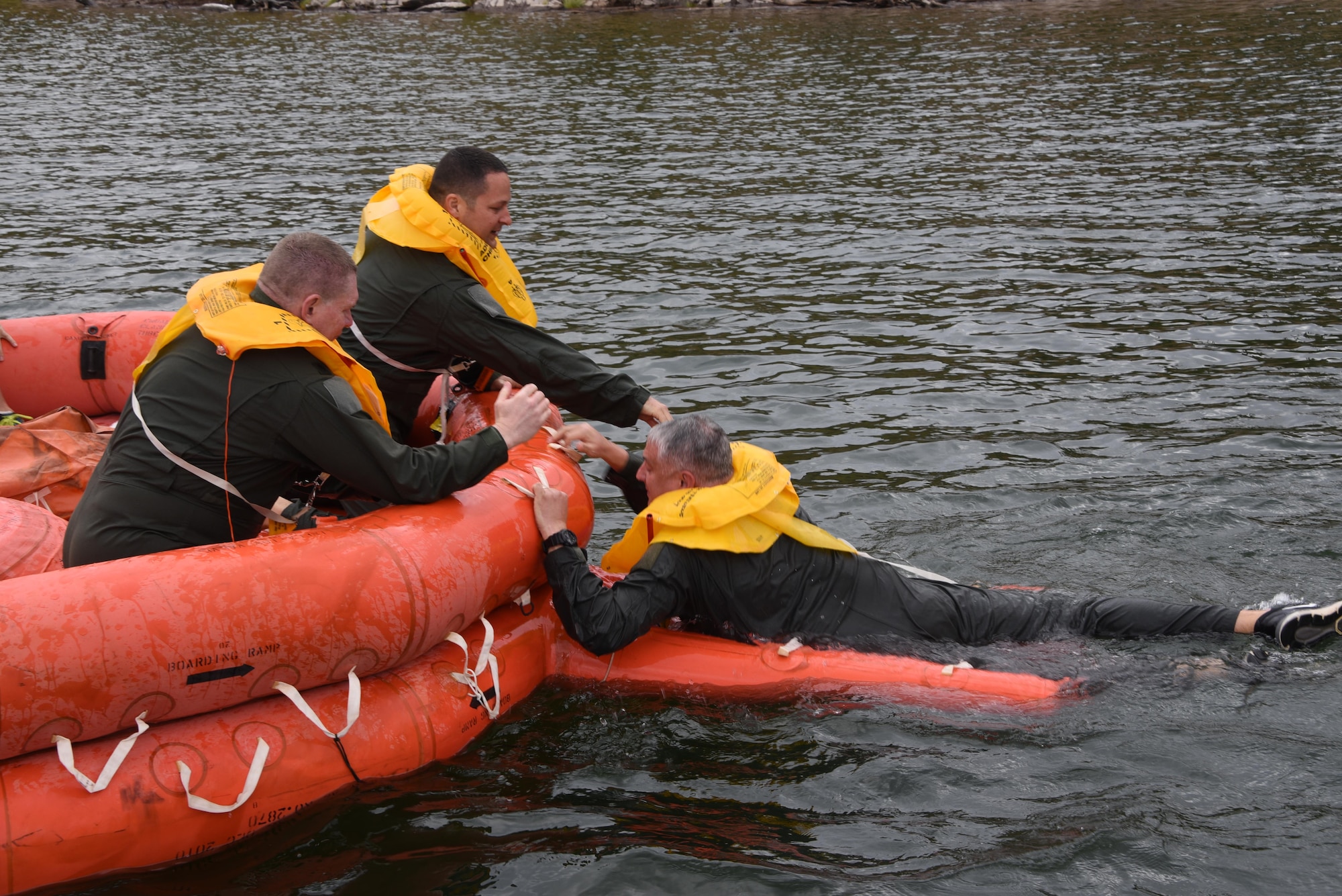 KC-135 Stratotanker aircrew members help one another aboard a 20-man life raft during water survival training at Lake Pleasant aquatic center, Ariz., May 7, 2017. Water survival training is conducted every two years at the 161st Air Refueling Wing to refresh the aircrew on using the life support equipment on board the aircraft in the event of an emergency. (U.S. Air Force photo by Tech. Sgt. Michael Matkin) 