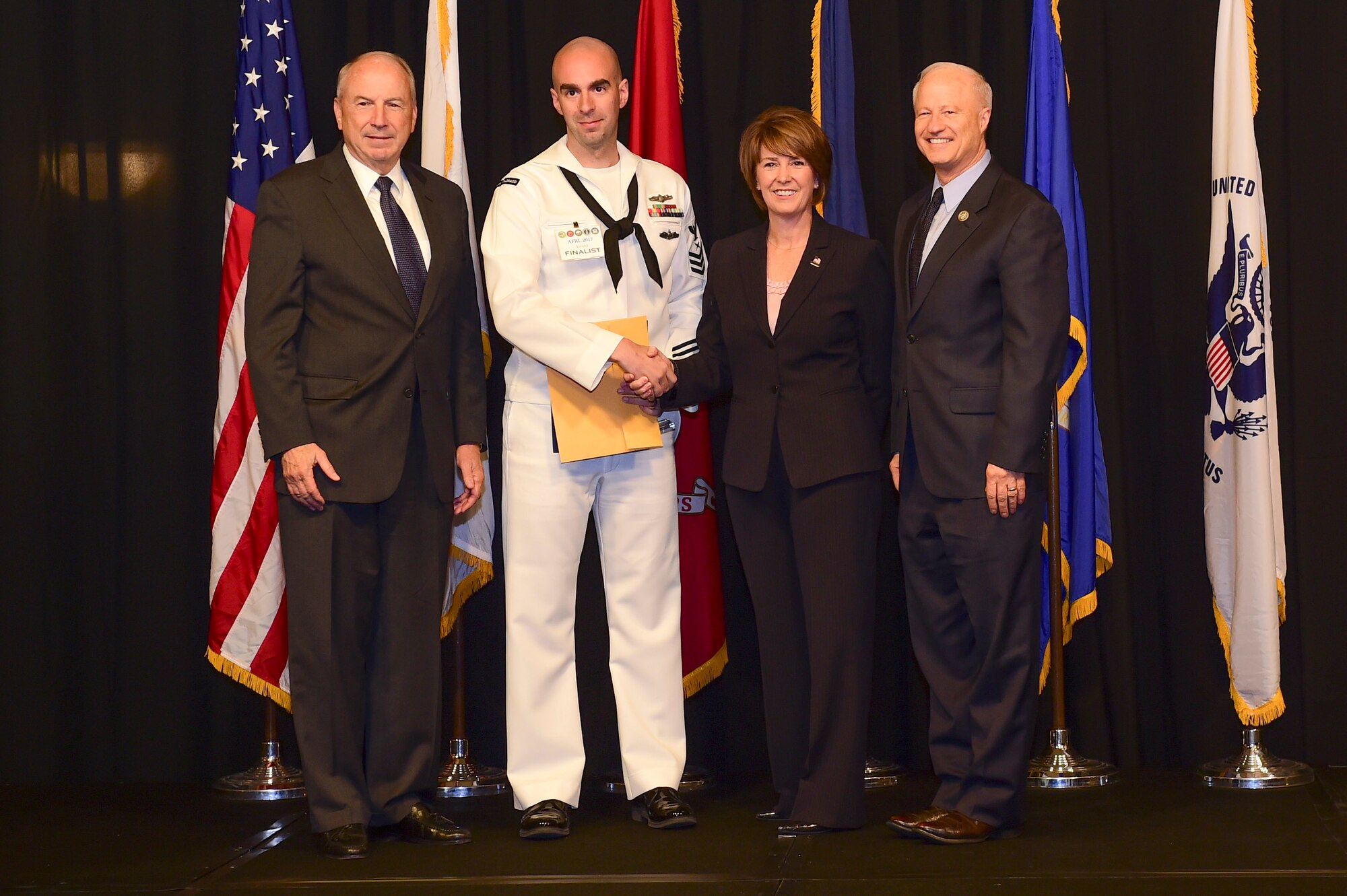 Petty Officer 1st Class Toby Gallt is awarded the active-duty Sailor of the year at the Armed Forces Recognition Luncheon May 5, 2017, at the DoubleTree by Hilton in Denver. The AFRL is an annual event hosted by the Aurora Chamber of Commerce in appreciation of Colorado’s active-duty, guardsmen and reservists. (U.S. Air Force photo by Airman Jacob Deatherage/Released)