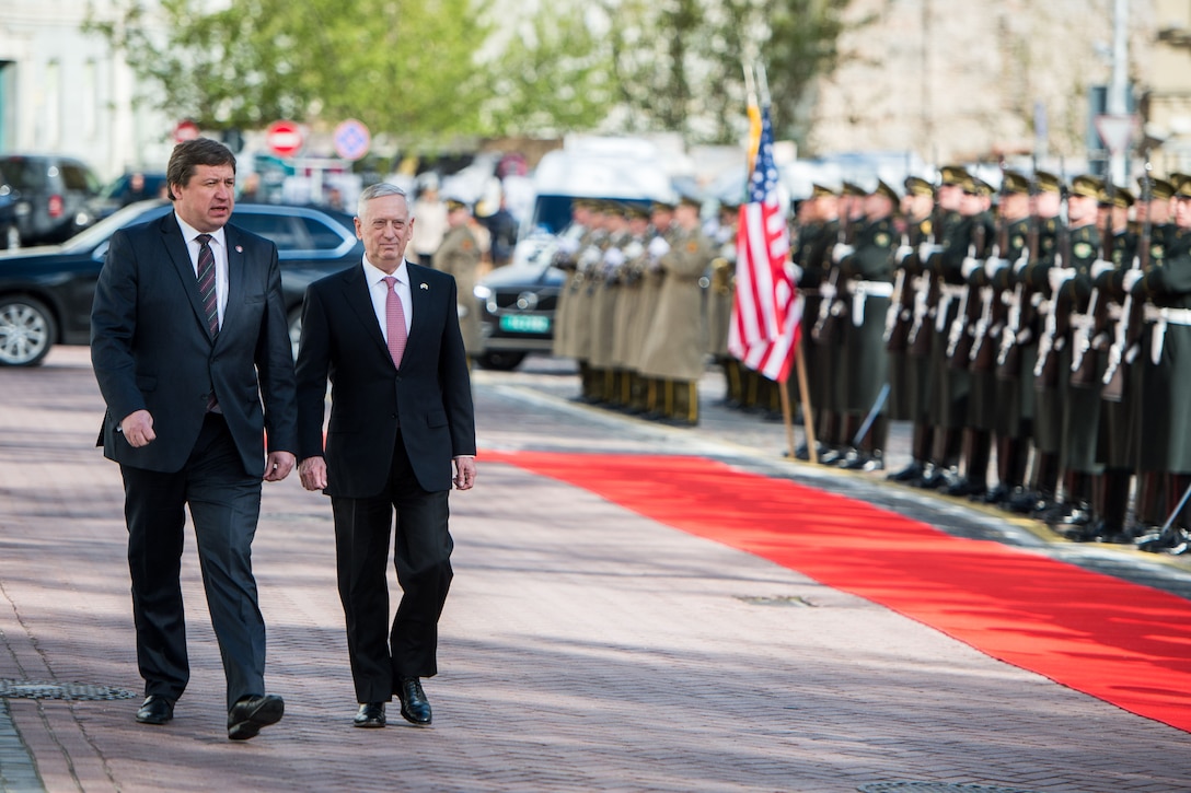 Defense Secretary Jim Mattis walks with Lithuanian Defense Minister Raimundas Karoblis