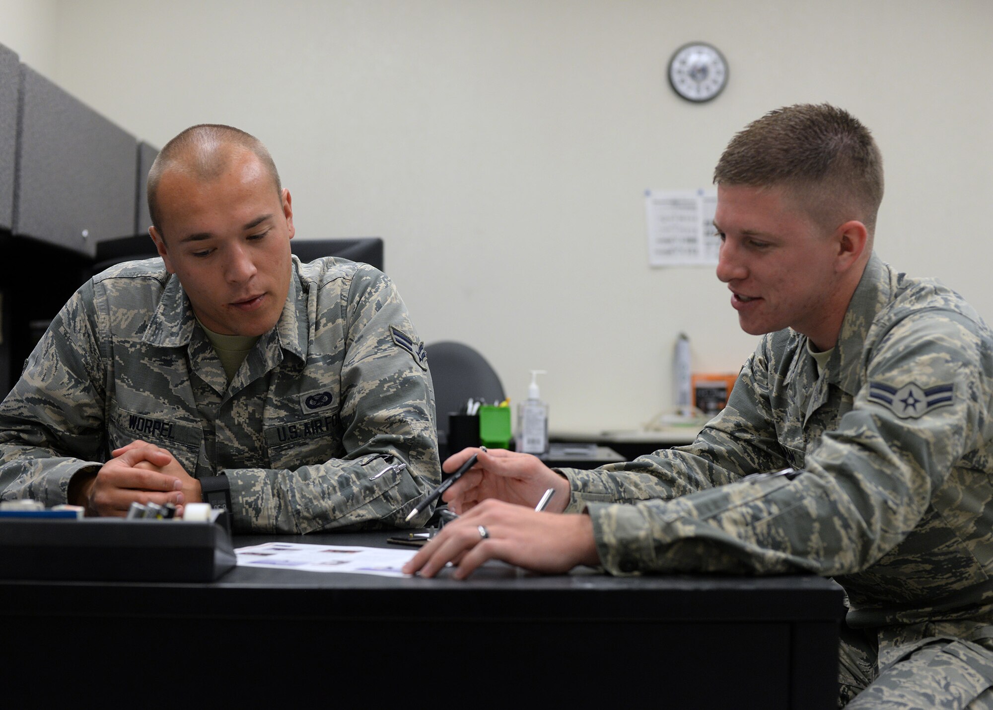 Airman 1st Class Clayton Selman, 56th Fighter Wing military justice paralegal, shows Airman 1st Class Caleb Worpel, 56th Fighter Wing photojournalist apprentice, the Air Force Assistance Fund charities he can choose to donate to May 5, 2017 at Luke Air Force Base, Ariz. The money collected by the campaign will fund four Air Force affiliated charities: the Air Force Villages Foundation, the Air Force Aid Society, the General and Mrs. Curtis E. LeMay Foundation and the Air Force Enlisted Village. (U.S. Air Force photo by Senior Airman Devante Williams)