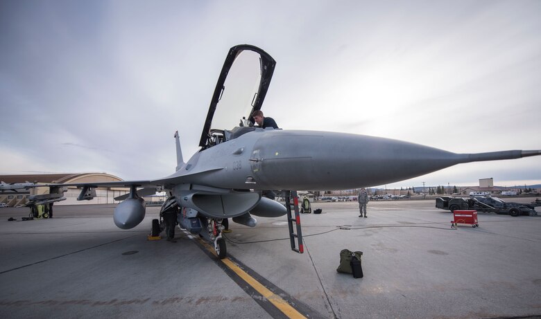 U.S. Air Force Airman 1st Class Andrew Harding a 13th Fighter Squadron crew chief, performs preflight inspections during Northern Edge 2017 at Eielson Air Force Base, Alaska, May 9, 2017. NE17 is a training exercise that provides effective, flexible and capabilities-centered joint forces ready for deployment worldwide and enables real-world proficiency in detection, identification and tracking.  (U.S. Air Force photo by Tech Sgt. Araceli Alarcon)