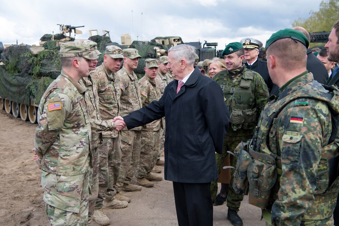 Defense Secretary Jim Mattis greets a U.S. service member while meeting with German, Lithuanian, Dutch, Belgian and American military members at Pabrade Training Area, Lithuania, May 10, 2017.