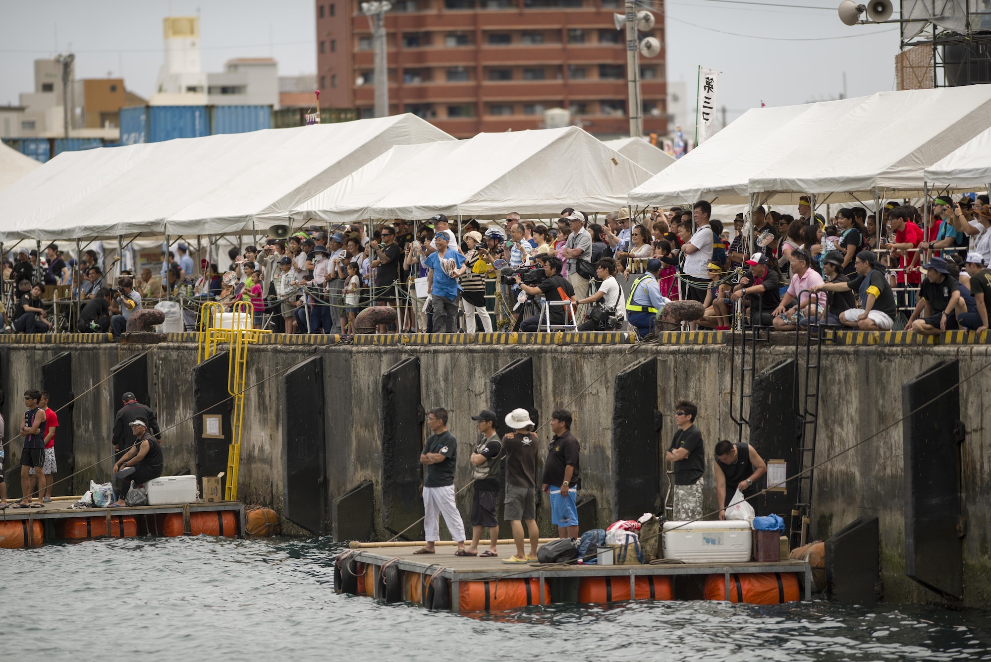 Thousands of spectators watch teams compete during the 43rd Annual Naha Dragon Boat Race May 5, 2017, at Naha Port, Japan. The Naha Dragon Boat Race is the largest dragon boat race on Okinawa with more than 50 competing teams. (U.S. Air Force photo by Senior Airman Omari Bernard)