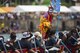 A dragon boat team member dressed in Ryuku traditional garb cheers on her teammates during the Naha Dragon Boat Race May 5, 2017, at Naha Port, Japan. The dragon boat teams, composed of 32 rowers, board long fiberglass boats painted to resemble mythical seafaring dragons. The race lasts less than 5 minutes as teams push their bodies to the limit. (U.S. Air Force photo by Senior Airman Omari Bernard)