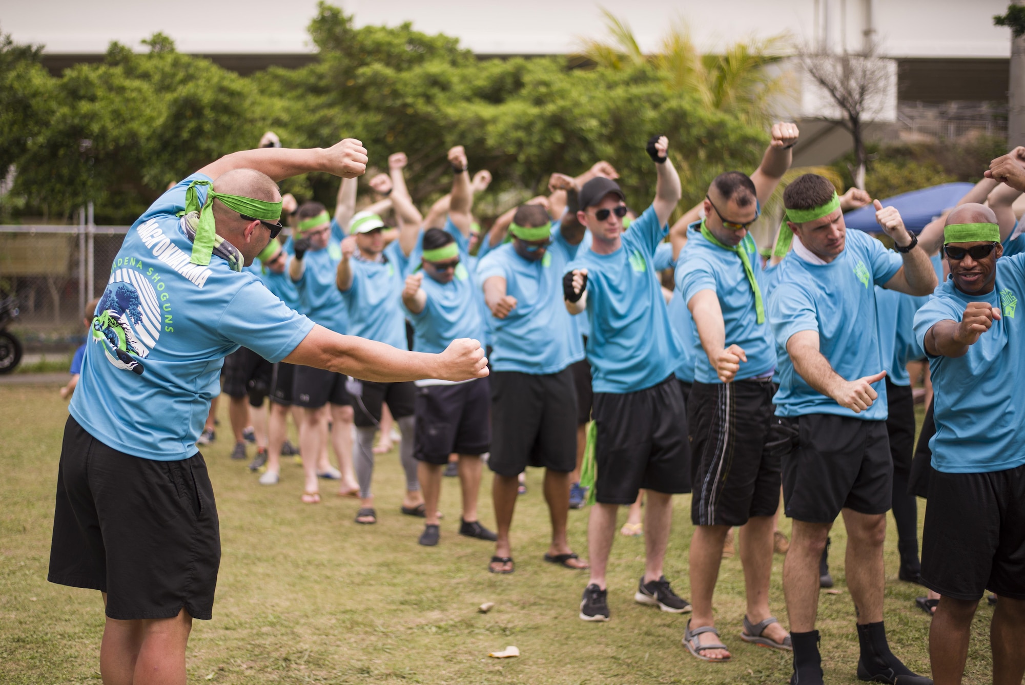 The Kadena Shoguns Men’s Dragon Boat Team warms up before their race at the 43rd Annual Naha Dragon Boat Race May 5, 2017 at Naha Port, Japan. The team practiced rowing in sync, which helps propel the boat at a faster speed during the race. (U.S. Air Force photo by Senior Airman Omari Bernard)