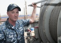 170509-N-XP344-033 MANAMA, Bahrain (May 9, 2017) Mineman 2nd Class Tyler Smith, a native of Munford, Ala. and assigned to the Avenger-class mine countermeasure ship USS Devastator (MCM 6), poses for a photo in front of Devastator’s sweep line. On April 23, Smith deployed to the Avenger-class mine countermeasure ship USS Dextrous (MCM 13) and repaired the ship’s swage, a thick metal clasp that secures the ship’s sweep wire and withstands up to 18,000 pounds of pressure. (U.S. Navy photo by Mass Communication Specialist 2nd Class Victoria Kinney)
