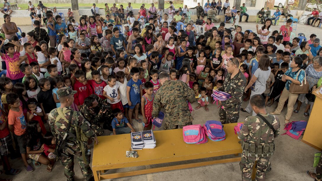 Philippine and U.S. service members present backpacks to excited children during a community relations event in support of Balikatan 2017 at Margen Elementary School in Ormoc, Leyte, May 2, 2017. U.S. military and Armed Forces of the Philippines service members hosted a community event for Ormoc City residents and closed with a community building event to boost camaraderie. Balikatan is an annual U.S.-Philippine bilateral military exercise focused on a variety of missions, including humanitarian assistance and disaster relief, counterterrorism, and other combined military operations. 