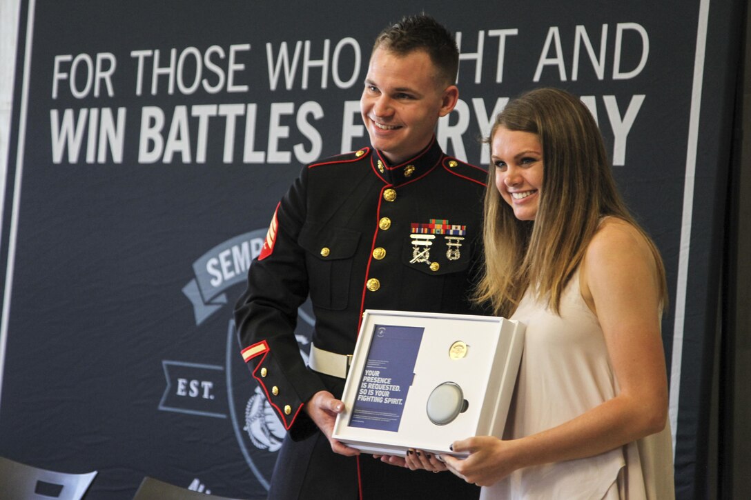 U.S. Marine Sgt. Roderick Evans presents Natasha Kusibab an invitation to attend the 2017 Battles Won Academy at Brentwood High School, Brentwood, Tennessee, on May 9, 2017. The Battles Won Academy will bring together 96 of the country’s top student-leaders July 13-17 in Washington D.C. The program provides Marines with several opportunities to purposefully engage the student leaders and share leadership lessons that will enhance their future success. (U.S. Marine Corps photo by Sgt. Mandaline Hatch)