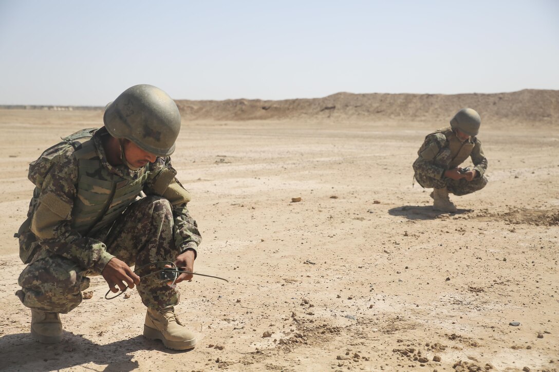 Afghan National Army soldiers with the 215th Corps prepare to tie demolition charges to a trunk line at Camp Shorabak, Afghanistan, May 10, 2017. More than 20 soldiers completed a demolition range as part of an explosive hazard reduction course, which provides students with the knowledge and skills to diminish the threat of improvised explosive devices. U.S. Marines with Task Force Southwest are assisting the Afghans throughout the training as part of NATO’s Resolute Support Mission to train, advise and assist the Afghan National Defence Security Forces. (U.S. Marine Corps photo by Sgt. Lucas Hopkins)