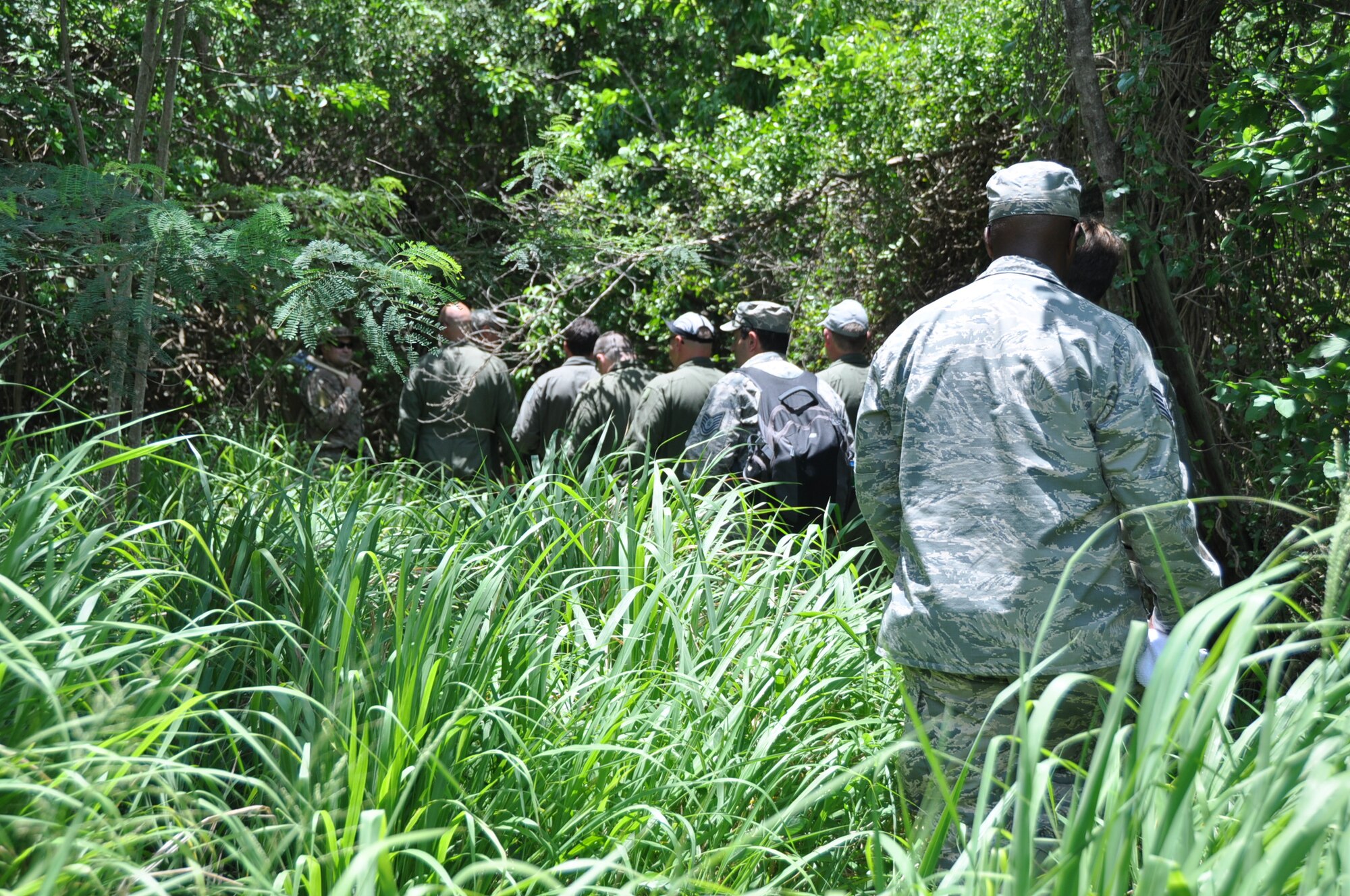 Members of the 53rd Weather Reconnaissance Squadron follow Technical Sgt. Karen Moore, 53rd WRS loadmaster, who leads the way using a compass during the land survival portion of Survival, Evasion, Resistance, and Escape (SERE) refresher training in the woods of St. Croix, U.S. Virgin Islands, May 9,2017. (U.S. Air Force photo//Master Sgt. Jessica Kendziorek)
