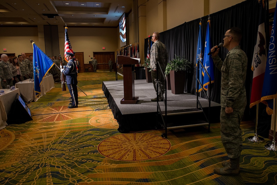 The 137th Special Operations Wing Honor Guard presents the colors while Capt. Paul Blankenship, 137 SOW Force Support Squadron food service officer, sings a stirring rendition of the national anthem to open the 2017 Air National Guard Leadership Conference at the National Center for Employee Development Conference Center, Norman, Okla., May 8, 2017. The leadership conference, attended by general officers, adjutant generals, wing commanders, command chiefs and directors of staff from across the 54 U.S. states and territories, focused on leading, protecting and supporting the 21st-century Guard Airman. (U.S. Air National Guard photo by Senior Master Sgt. Andrew M. LaMoreaux)