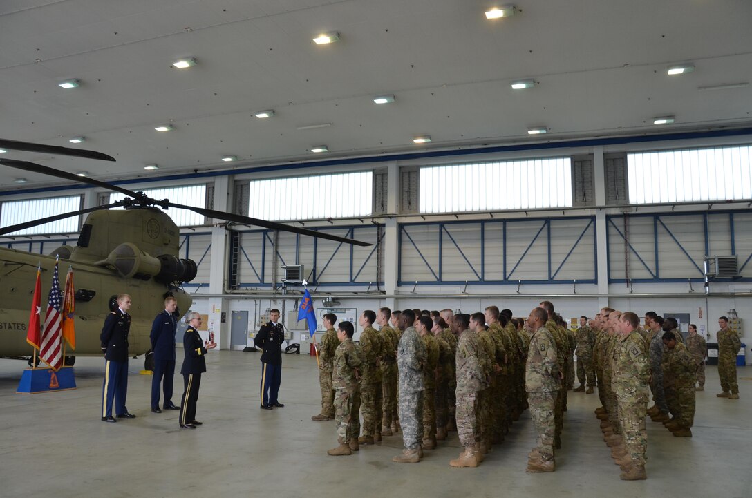 A joint promotion ceremony took place May 8 at a Katterbach Army Airfield hangar here, during which a one-star general promoted her two sons (one in the Air Force and one in the Army) to the rank of captain. Brig. Gen. Lisa Doumont, who serves both as the assistant surgeon general for Reserve Affairs out of Falls Church, Virginia, and as the deputy commanding general for the Army Reserve Medical Command out of Tampa, Florida, oversaw the promotion ceremony of Capt. Nicholas Doumont, an executive officer at the Air Force Research Lab at Wright-Patterson Air Force Base, Ohio, and Capt. Patrick Doumont, maintenance platoon leader and executive officer for B Company, 1st Battalion, 214th Aviation Regiment (General Support / VIP Fixed Wing), here at U.S. Army Garrison Ansbach. (U.S. Army photo by Bryan Gatchell, USAG Ansbach Public Affairs)