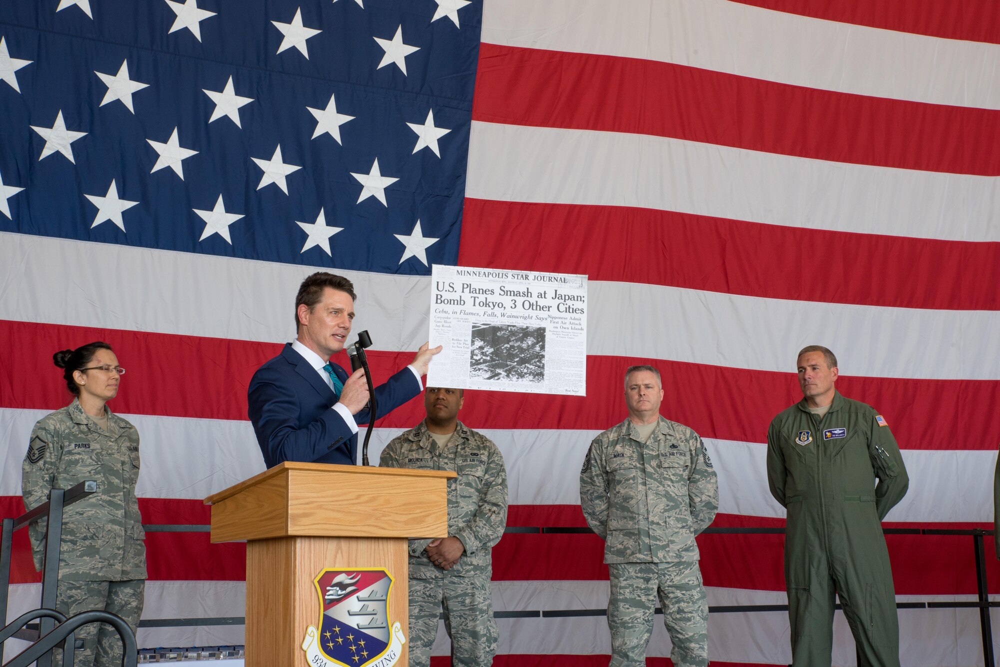 Tim Blotz, Fox 9 news anchor and reporter, holds a copy of the Minneapolis Star Journal from 1942 while speaking about the 75th anniversary of the Doolittle raid and Minnesota's contribution to the effort. (Air Force Photo/Master Sgt. Eric Amidon)