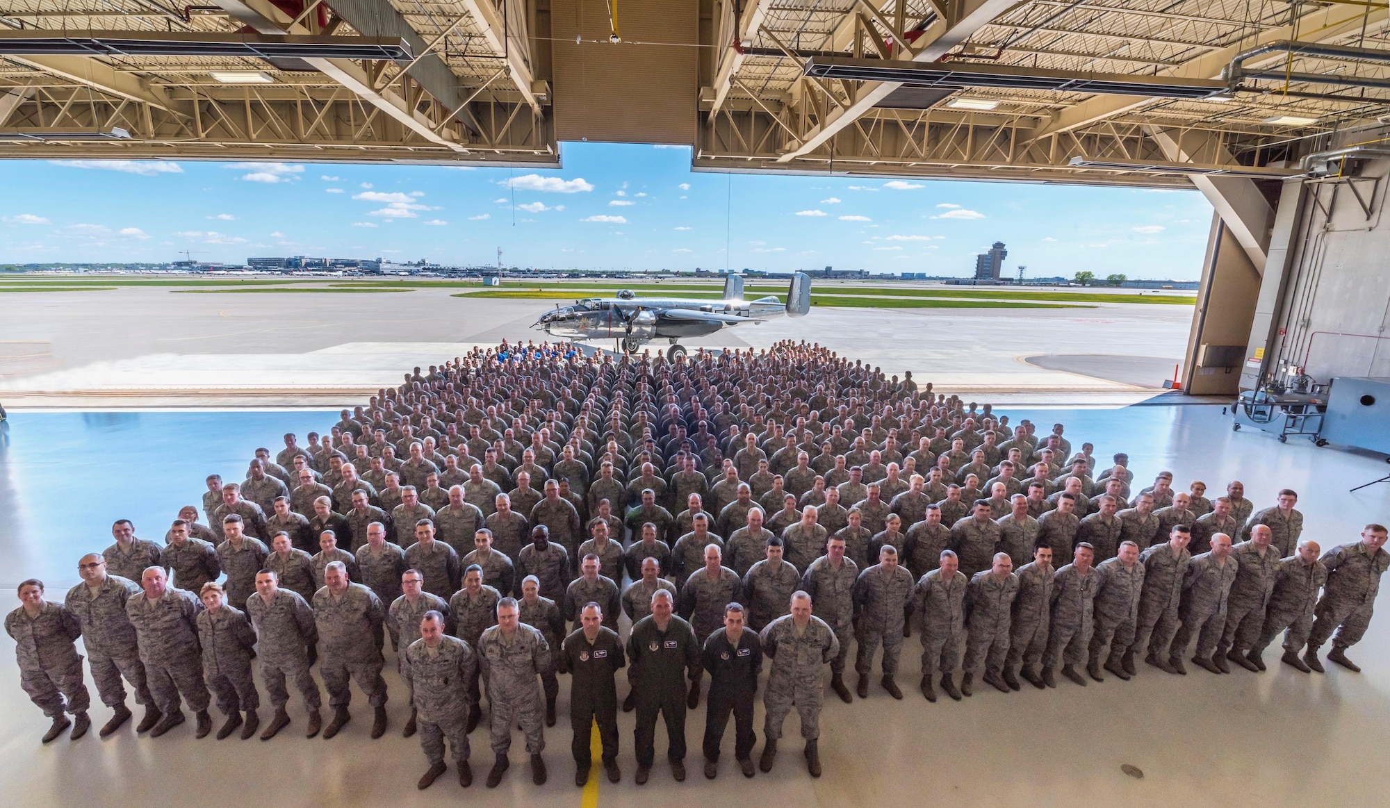 Members of the 934th Airlift Wing stand in formation in front of a World War II B-25 "Mitchell" bomber paying homage to the Doolittle raid conducted 75 years earlier. (Air Force Photo/Master Sgt. Eric Amidon)