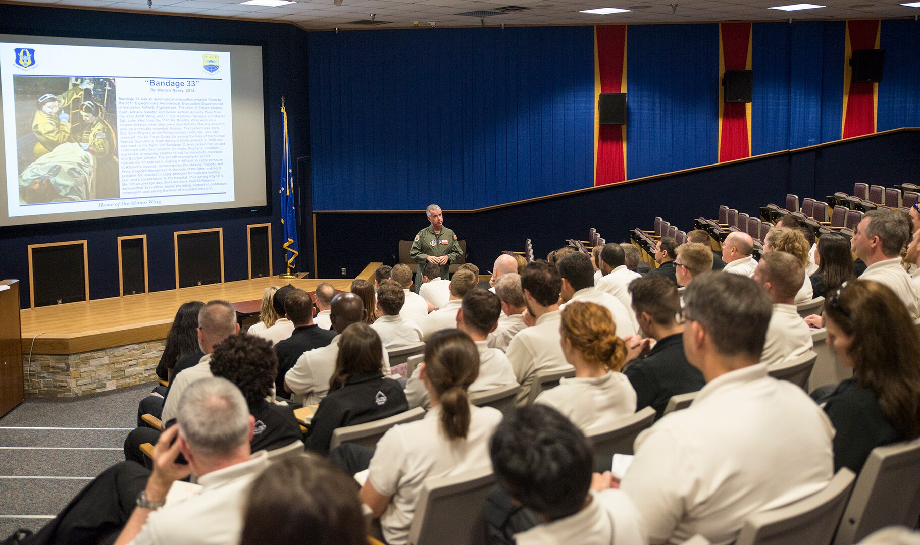 Col. David Scott, 433rd Airlift Wing vice commander, gives a wing mission brief to members of the  Department of Defense Executive Leadership Development Program May 10, 2017 at Joint Base San Antonio-Lackland, Texas. The group also visited the 433rd Aircraft Maintenace Squadron fabrications flight and a static C-5M Super Galaxy aircraft. (U.S. Air Force photo by Benjamin Faske)