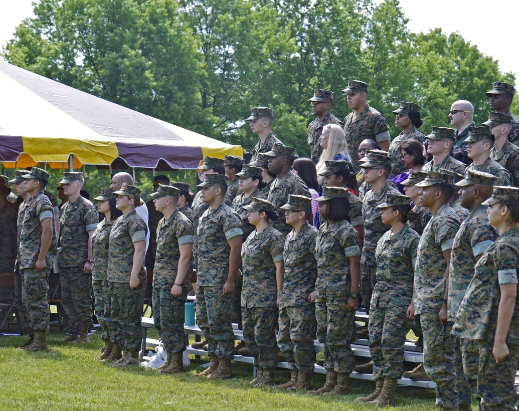 Marines attending the Centennial Celebration stand at attention as the Marine's Hymn is played.