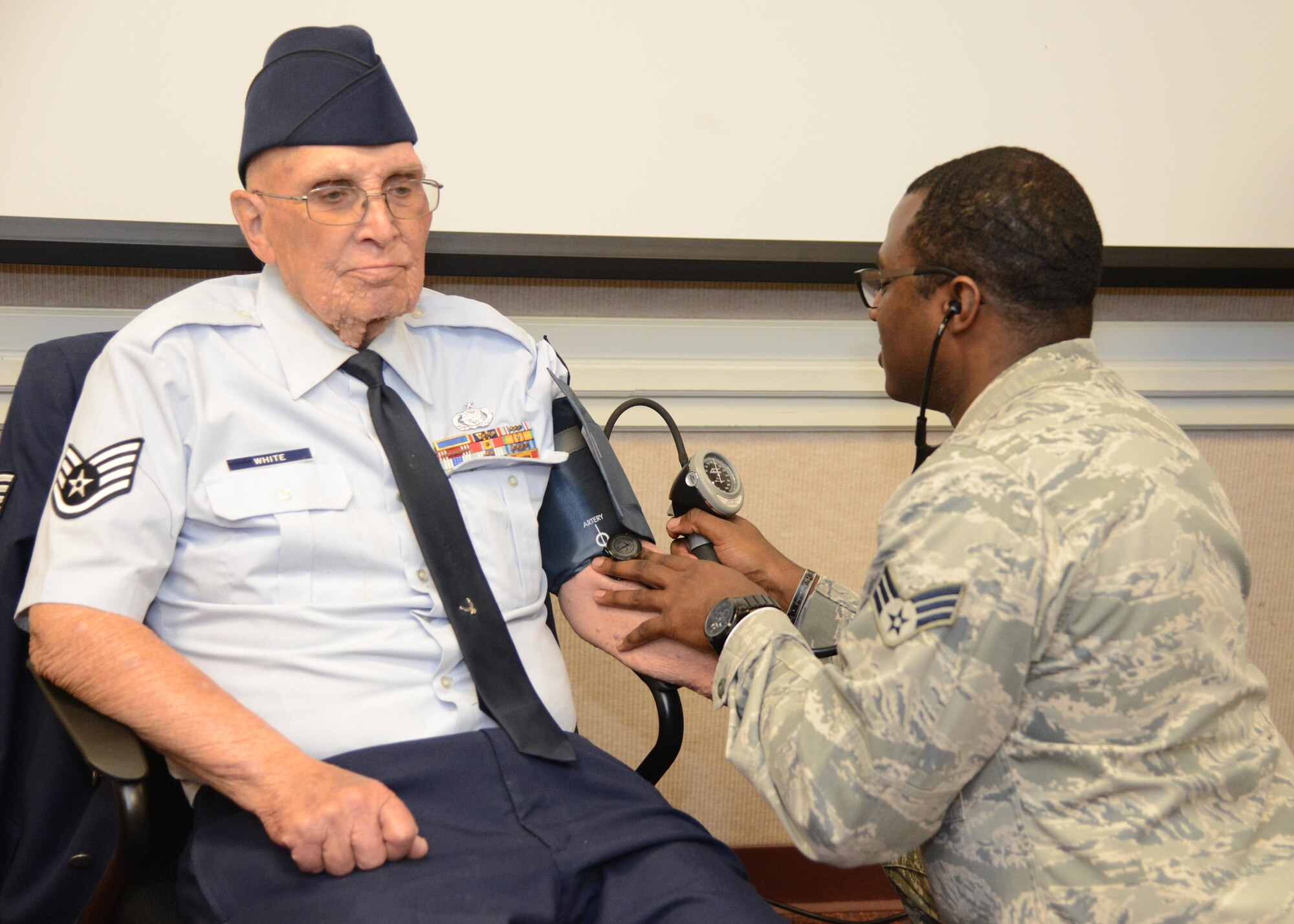 Retired Staff Sgt. Thomas White gets his blood pressure checked by Senior Airman Linwood Fields, 412th Medical Group Aerospace Medical technician. White served with the U.S. Air Force from 1954 to 1974 in supply and logistics. Edwards AFB held its annual Retiree Appreciation Day May 6. (U.S. Air Force photo by Christopher Ball)