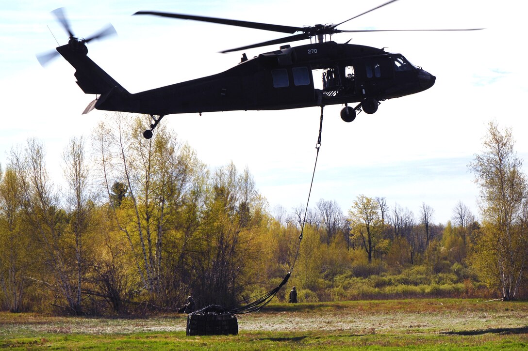 A New York Army National Guard UH-60 Black Hawk helicopter delivers 105 mm howitzer ammunition at Fort Drum, N.Y., to be used during a live-fire exercise by soldiers from the 10th Mountain Division, May 4, 2017. New York Army National Guard photo by Master Sgt. Raymond Drumsta
