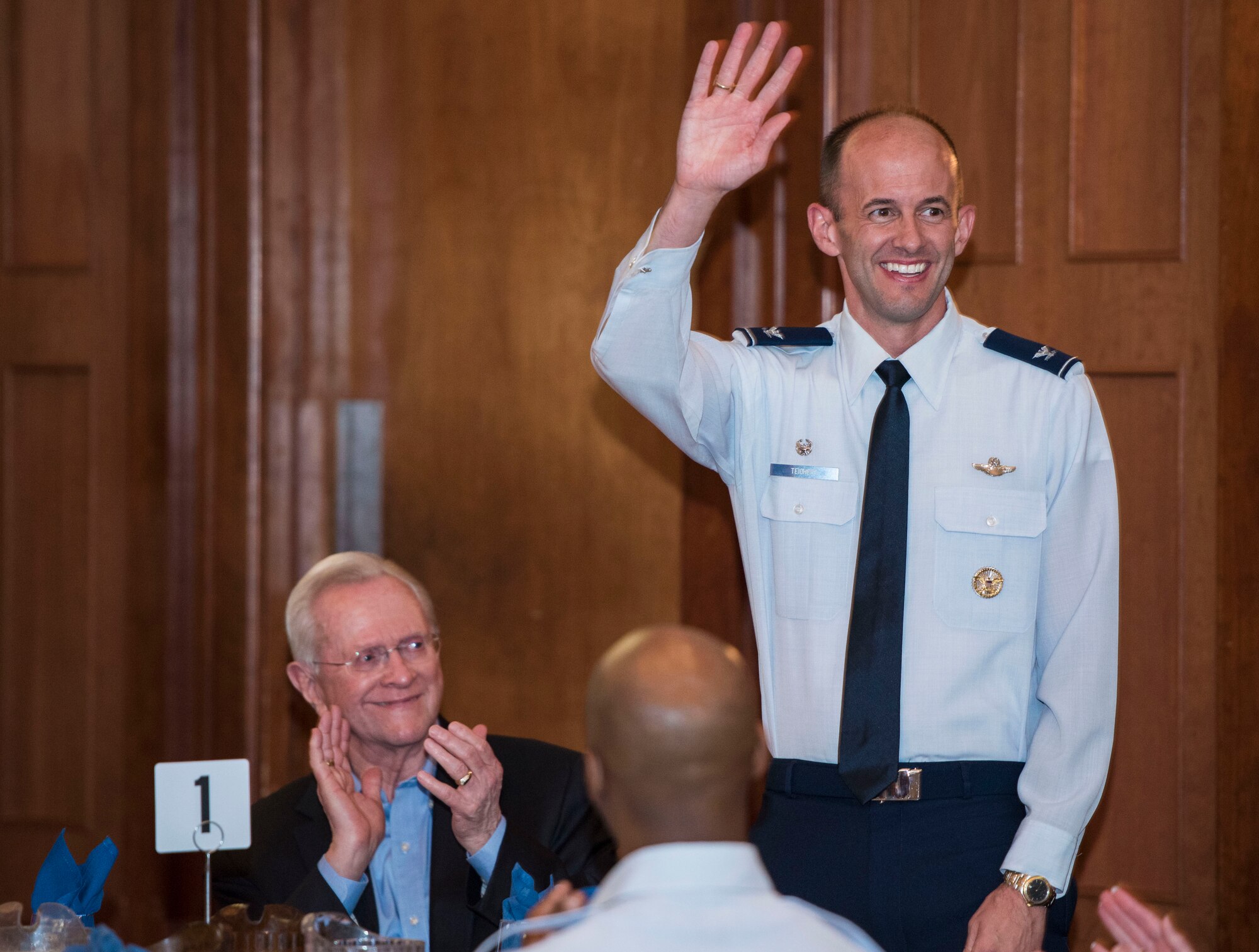 Col. E. John Teichert, 11th Wing and Joint Base Andrews commander, waves at the beginning of the honorary commander ceremony at Joint Base Andrews, Md., May 5, 2017. The annual ceremony was held for approximately 40 participants who were either inducted to, recognized for or retired from the program. (U.S. Air Force photo by Senior Airman Jordyn Fetter)