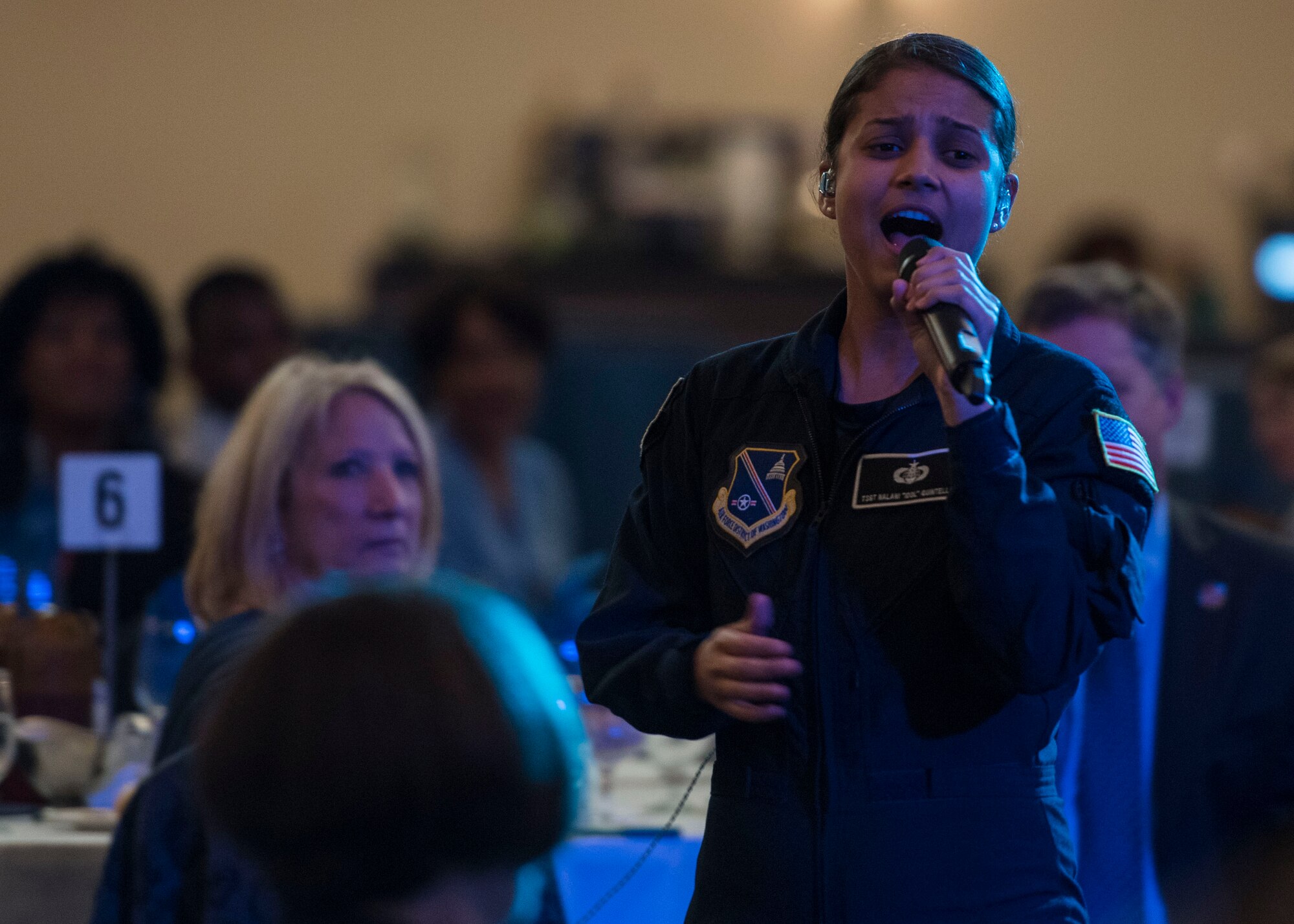 Tech. Sgt. Nalani Quintello, U.S. Air Force Band’s premier rock band vocalist, performs during the honorary commander ceremony at Joint Base Andrews, Md., May 5, 2017. The community outreach event welcomed, recognized and retired members of the JBA Honorary Commanders Program at different stages of their two-year term. During their time in the program, honorary commanders are invited to participate in various installation events like orientations, mission briefs, tours and air shows. (U.S. Air Force photo by Senior Airman Jordyn Fetter)