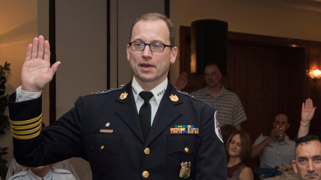 Henry Stawinski, Prince George’s County police chief and honorary commander, take an oath for admission to the JBA Honorary Commanders Program at Joint Base Andrews, Md., May 5, 2017. The community outreach event welcomed, recognized and retired members of the program at different stages of their two-year term. The program, which began in 1999, matches a community leader with a military leader to provide commanders a means to educate participants about the armed forces and their various missions. (U.S. Air Force photo by Senior Airman Jordyn Fetter)
