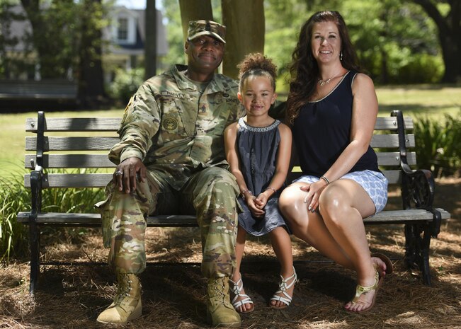 Army Sgt. Maj. Nathaniel Harvey III, 841st Transportation Battalion sergeant major sits with his wife, Tracie Harvey, and their daughter on a bench at Azalea Park in Summerville, S.C., May 10, 2017. Tracie Harvey worked as a civilian physical therapy assistant at the Walter Reed National Military Medical Center in Maryland. In 1999, Congress designated the Friday before Mother’s Day as Military Spouse Appreciation Day to show appreciation for the sacrifices of military spouses.