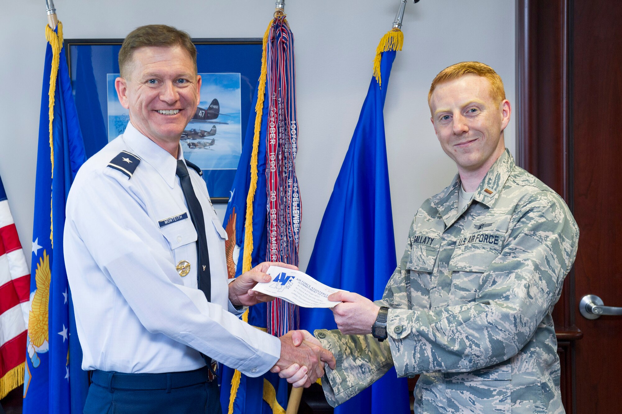 Brig. Gen. Wayne Monteith, 45th Space Wing commander, gives his Air Force Assistance Fund donation form to 2nd Lt. Walter Gallaty, 1st Range Operations Squadron officer and AFAF project officer, May 10, 2017, at Patrick Air Force Base, Fla. The Air Force Assistance Fund campaign began April 10, 2017, and runs through May 19, 2017. The Air Force Assistance Fund is an annual effort to raise funds for the charitable affiliates that provide support to Air Force families in need; such as: active duty, retirees, reservists, guard and dependents, including surviving spouses. (U.S. Air Force photo by Phil Sunkel)  