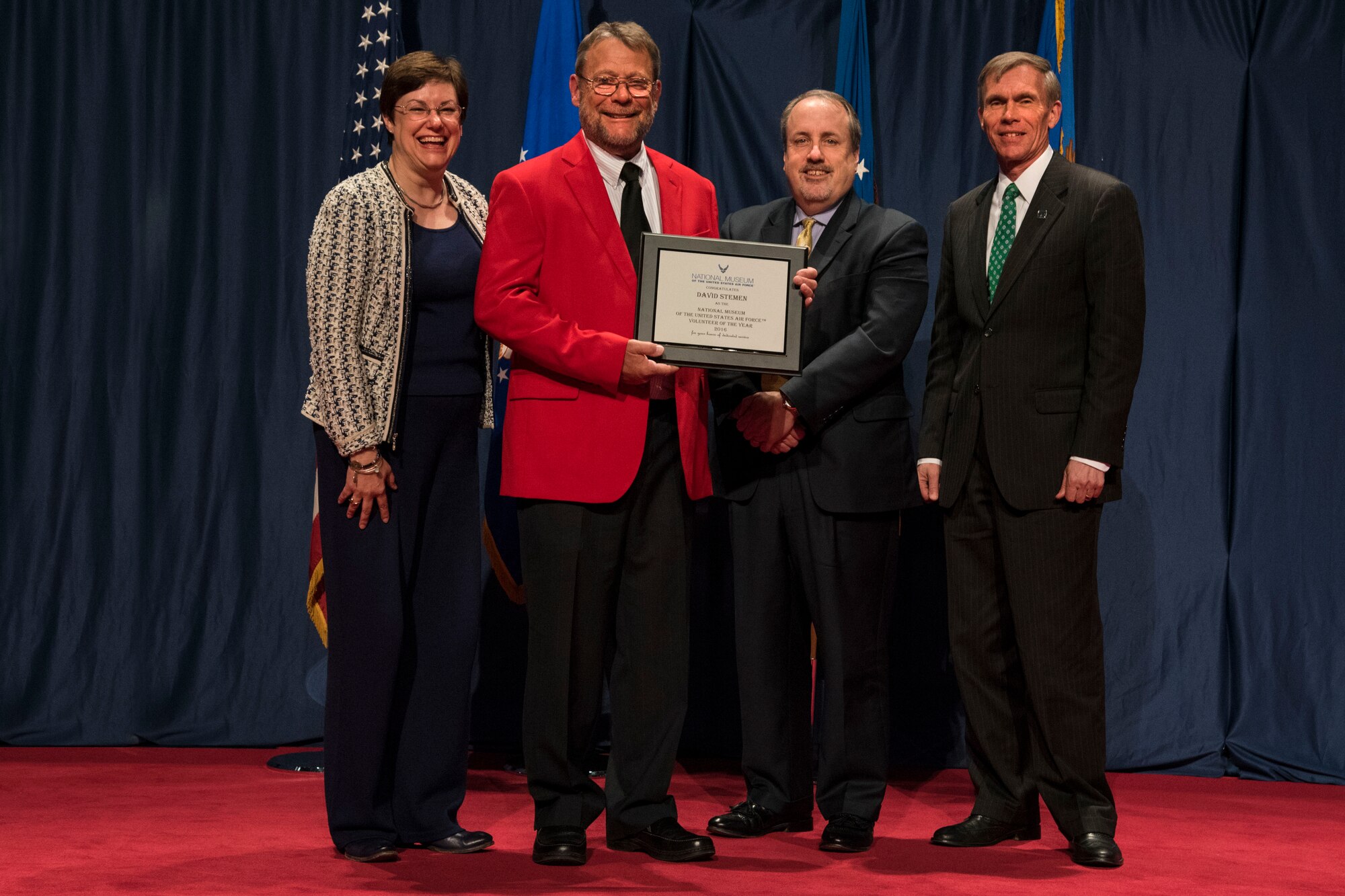 DAYTON, Ohio -- David Stemen (red jacket) received the 2016 Director’s Award for Volunteer of the Year for his dedication and excellence in serving the National Museum of the U.S. Air Force. (from left to right) Air Force Materiel Command Executive Director Patricia M. Young, Volunteer David Stemen, Air Force Museum Foundation Executive Director Michael P. Imhoff and Museum Director Lt. Gen.(Ret.) Jack Hudson. (U.S. Air Force photo) 