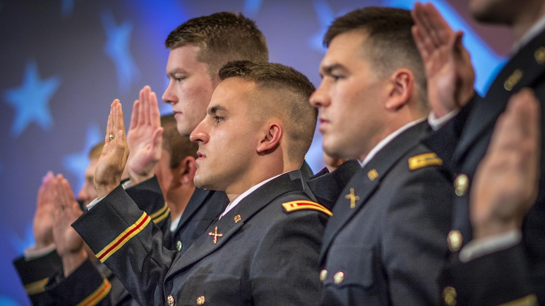 Allen Robertson, center, and 14 other Army ROTC cadets take the oath of office to become second lieutenants during a commissioning ceremony at Clemson University, S.C., May 10, 2017. Army photo by Staff Sgt. Ken Scar