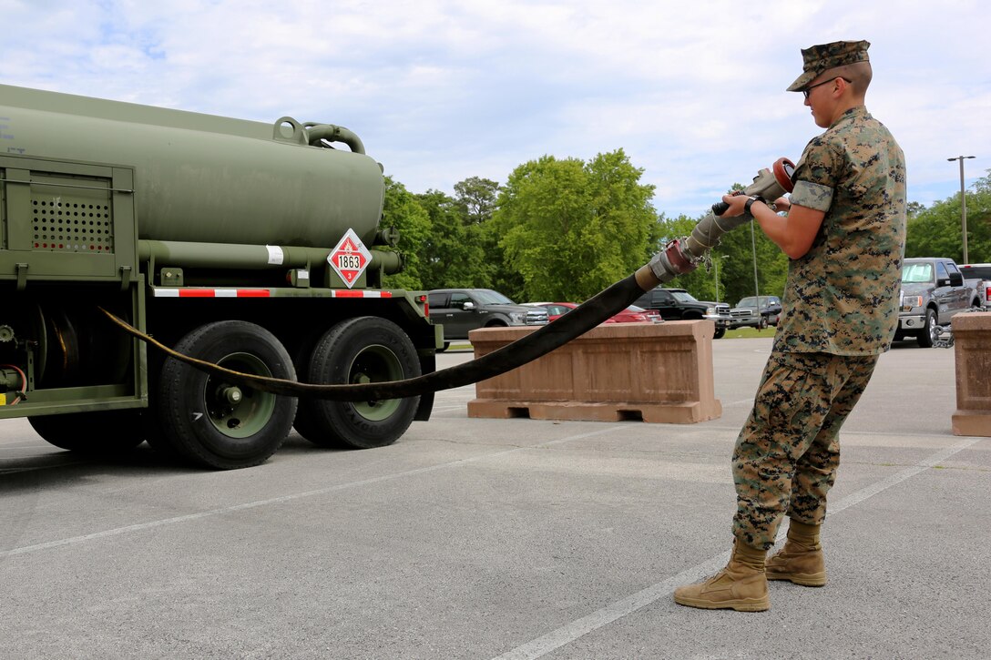 Pfc. Jacob Hankins pulls a hose from the fueling compartment of a M970 semitrailer refueler truck during a Semitrailer Refueler Operator Course at Marine Corps Air Station Cherry Point, N.C., May 9, 2017. Marines are evaluated upon completing four tests; three written and one road test. Upon completion of the course, motor transport Marines gain the secondary military occupational specialty, semitrailer refueler operator. Hankins is a motor transport operator with 2nd Transport Battalion, Combat Logistics Regiment 2, 2nd Marine Logistics Group. (U.S. Marine Corps photo by Cpl. Jason Jimenez/ Released)