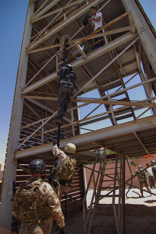 U.S., Italian and Jordanian military members climb a repel tower during a joint exercise at Eager Lion 2017.  Eager Lion is an annual U.S. Central Command exercise in Jordan designed to strengthen military-to-military relationships between the U.S., Jordan and other international partners. This year's iteration is comprised of about 7,200 military personnel from more than 20 nations that will respond to scenarios involving border security, command and control, cyber defense and battlespace management.  (U.S. Army photo by Sgt. Mickey A. Miller)